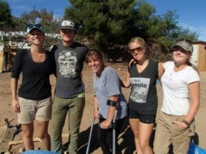 Group of smiling friends outdoors on a sunny day.