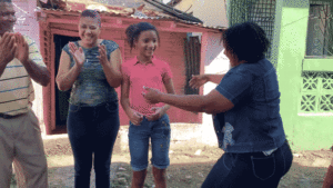 Family clapping and dancing outdoors, enjoying together.