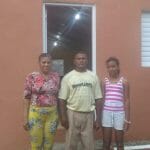 Family standing in front of a house.
