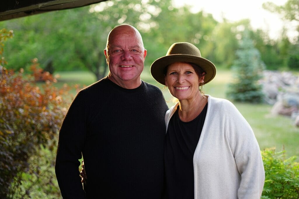 Smiling couple outdoors in sunny garden