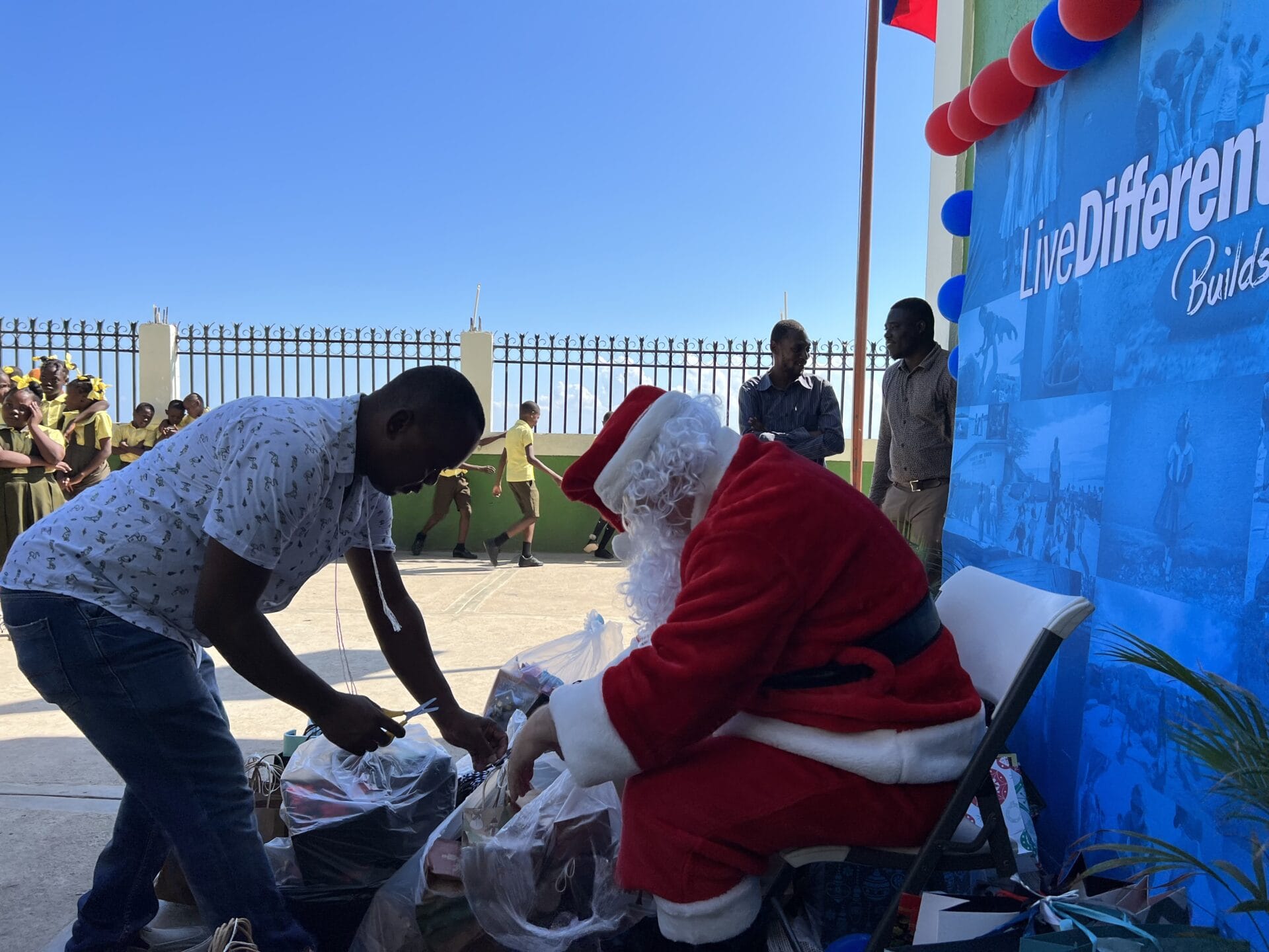Santa distributing gifts at outdoor event
