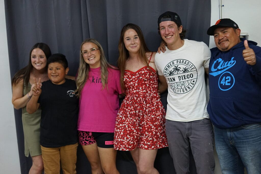Group of people smiling and posing together.